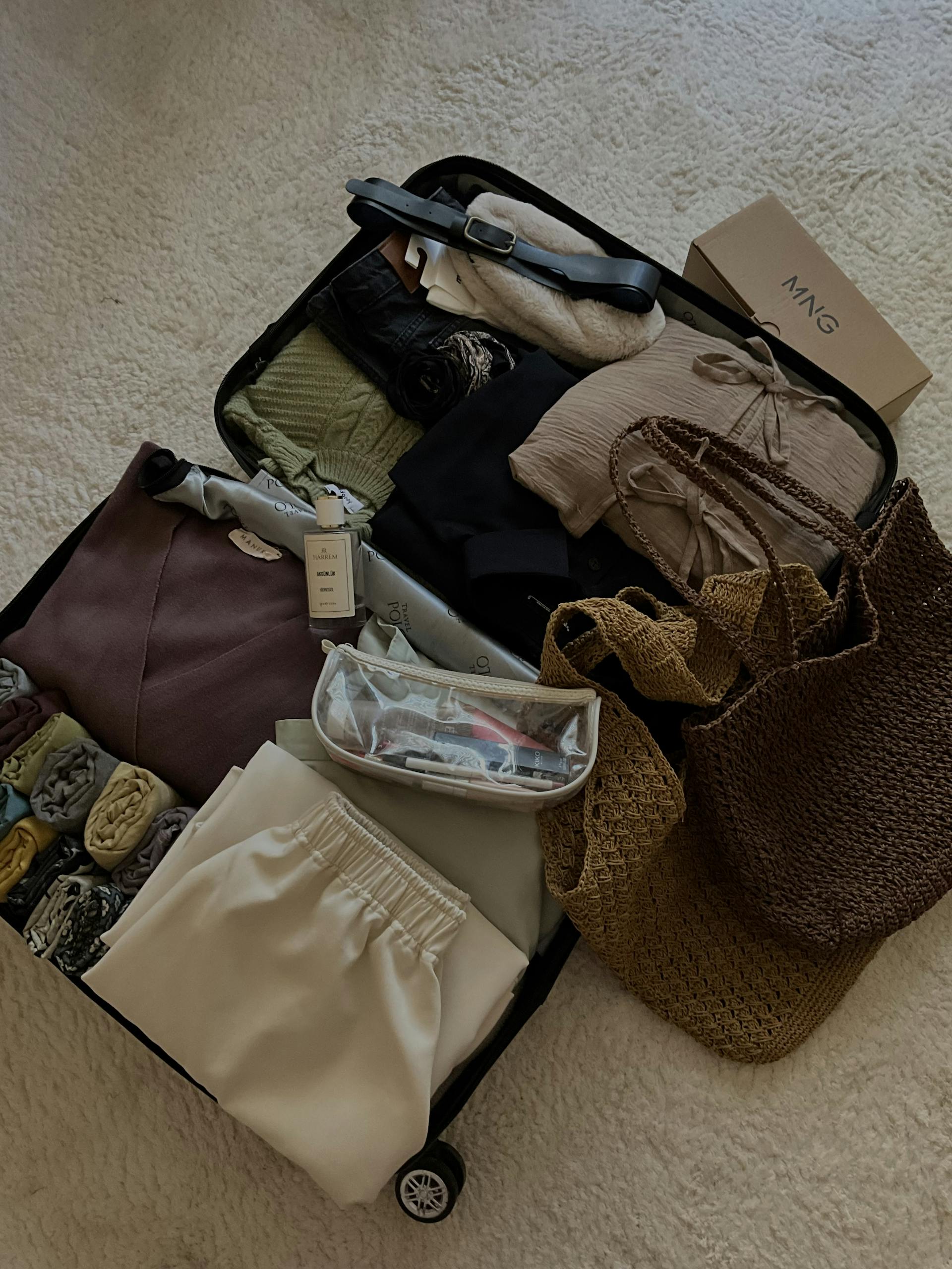 A suitcase neatly packed with clothes, accessories, and travel essentials for a chic vacation.